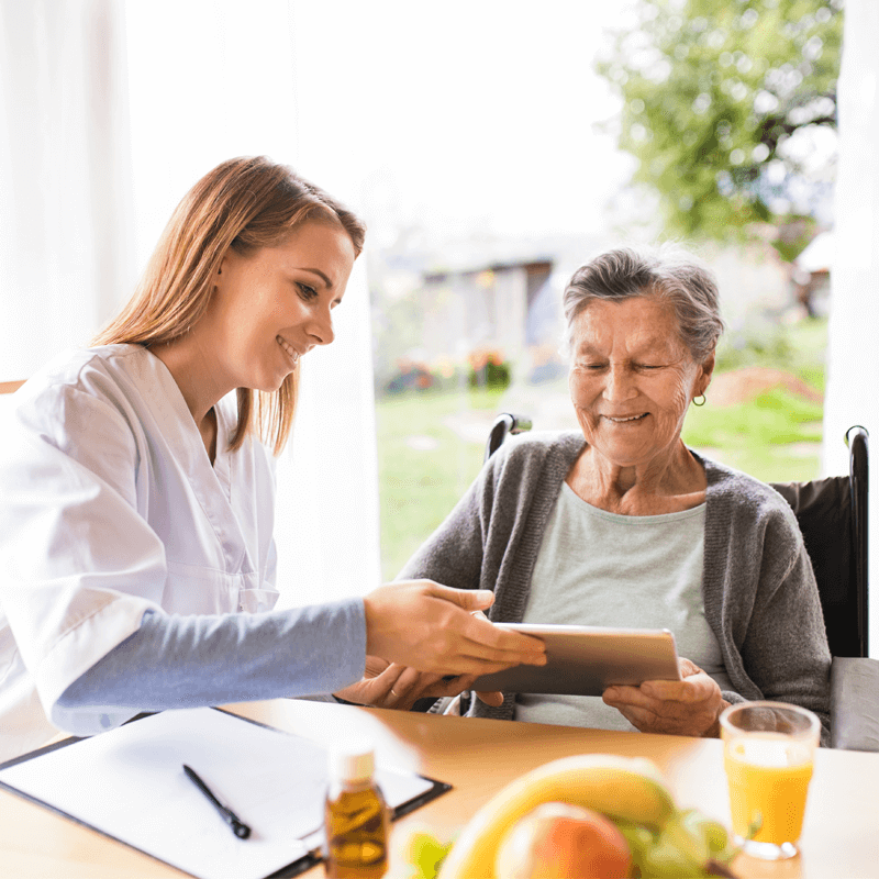 Helping lady use tablet